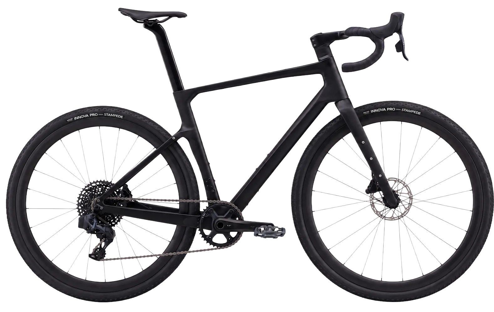 The Prisma Terra gravel bike in full side profile — matte-black T800 carbon frame, Shimano GRX drivetrain and wide all-road tyres.